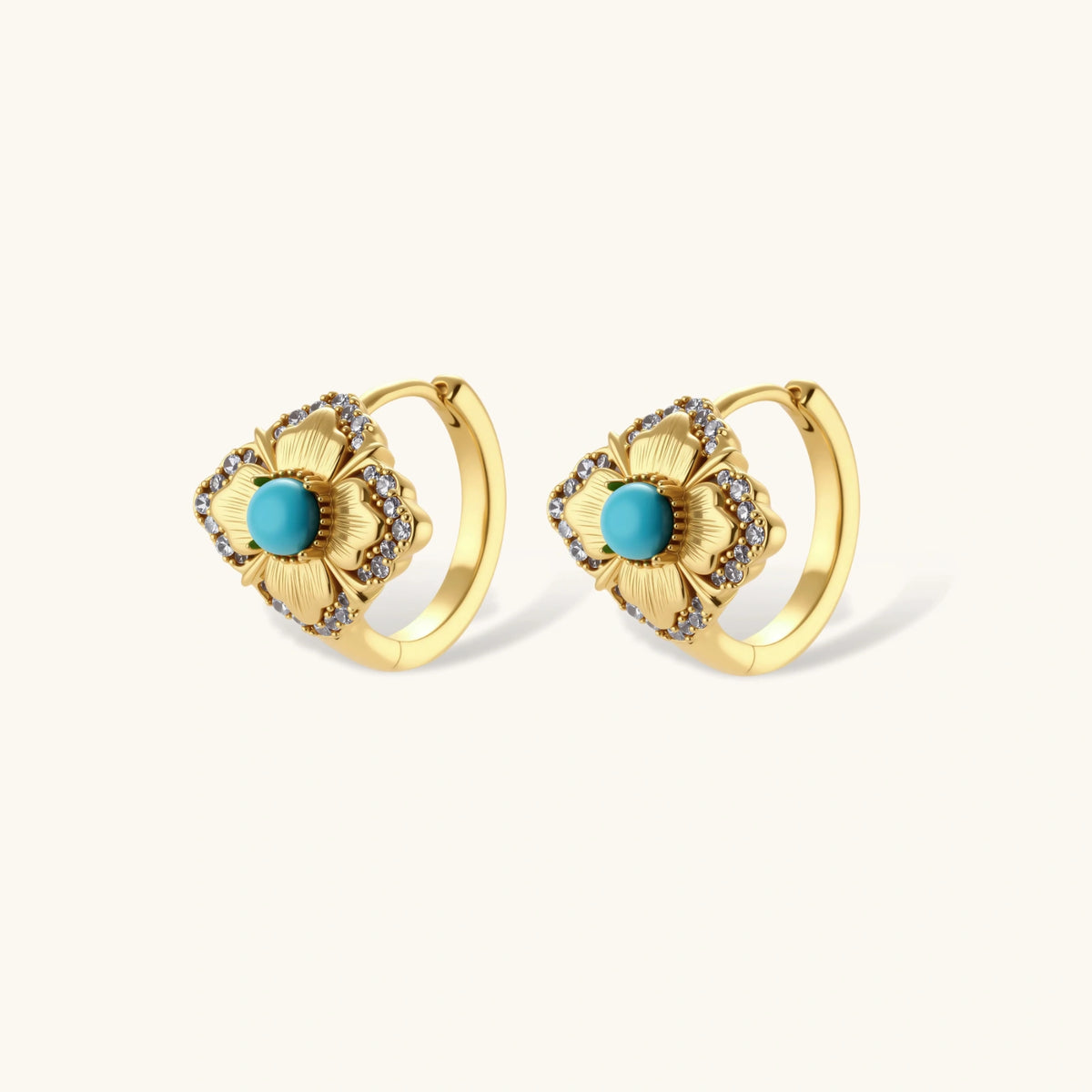 Close-up of 18K gold plated hoop earrings with turquoise center stones and zircon crystals in quatrefoil flower design