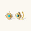 Close-up of 18K gold plated hoop earrings with turquoise center stones and zircon crystals in quatrefoil flower design